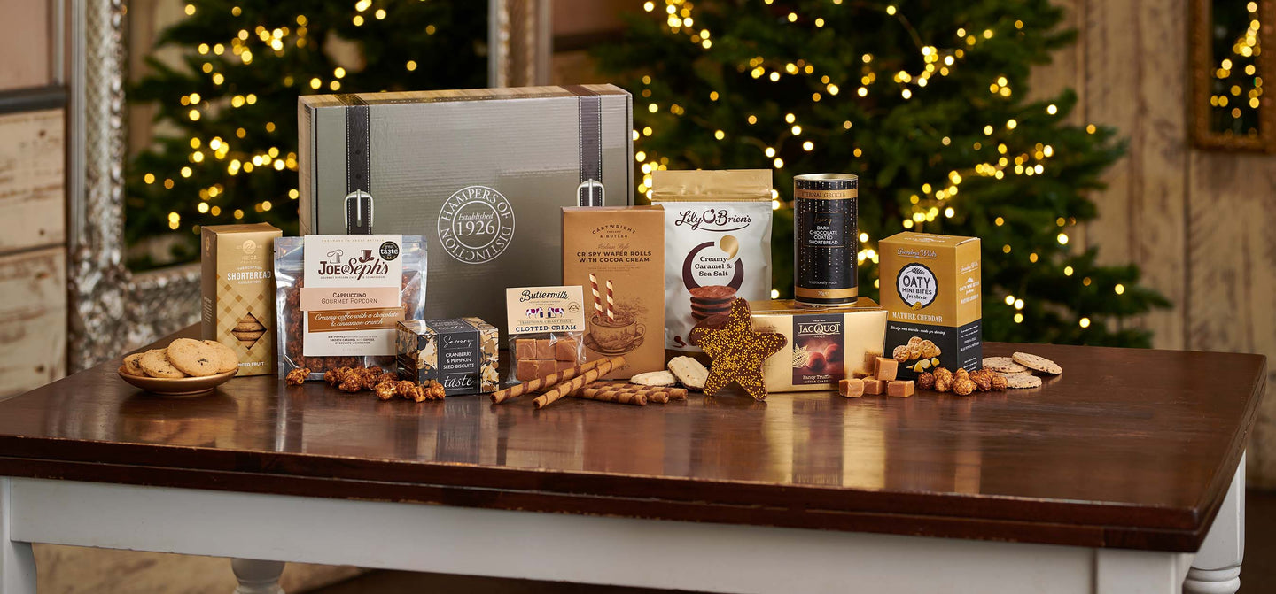 Alcohol free hamper laid in front of a Christmas tree on a table